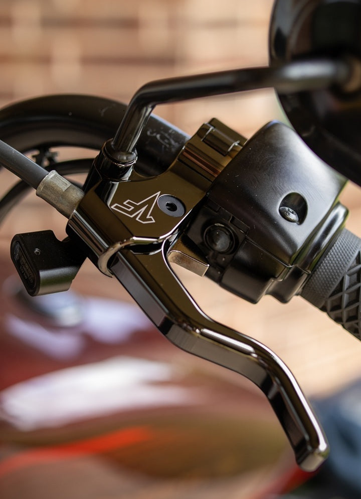 Close-up image of black chrome easy pull clutch lever on harley